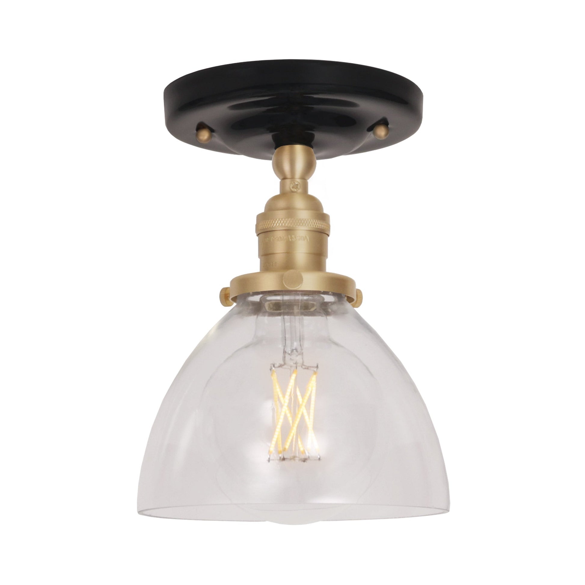 Grace Surface shown in Brass with a Gloss Black Ceramic canopy and Clear Glass shade