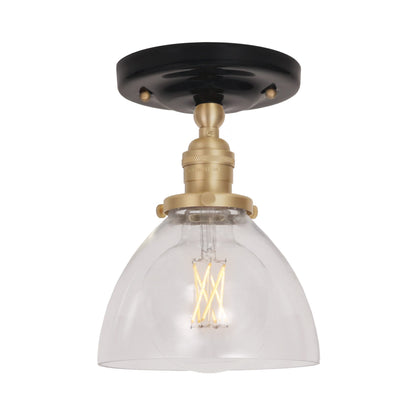 Grace Surface shown in Brass with a Gloss Black Ceramic canopy and Clear Glass shade