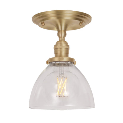 Grace Surface shown in Brass with a Clear Glass shade