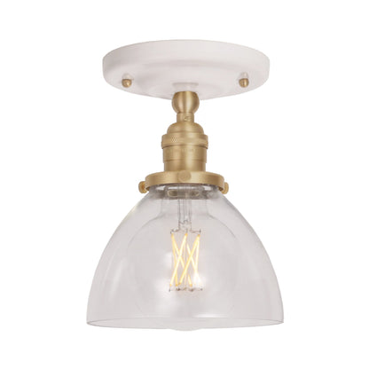 Grace Surface shown in Brass with a Gloss White Ceramic canopy and Clear Glass shade